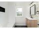Beautifully renovated bathroom with a modern vanity, sleek black fixtures, and tiled shower at 10745 Southeastern Ave, Indianapolis, IN 46239