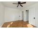 Bedroom featuring new hardwood floors and a ceiling fan plus an adjacent door at 10745 Southeastern Ave, Indianapolis, IN 46239