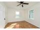 Bedroom featuring two double-hung windows and hardwood floors plus a ceiling fan at 10745 Southeastern Ave, Indianapolis, IN 46239
