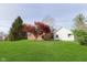 View of house with a huge yard with mature landscaping and a well-manicured lawn at 10745 Southeastern Ave, Indianapolis, IN 46239