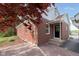 Charming brick home exterior showcasing a brick driveway and covered entrance at 10745 Southeastern Ave, Indianapolis, IN 46239