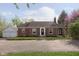 Attractive brick home with a well-manicured lawn and a detached two car garage at 10745 Southeastern Ave, Indianapolis, IN 46239