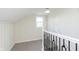 Hallway features white wainscotting and a staircase with black metal railing at 10745 Southeastern Ave, Indianapolis, IN 46239