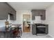 Bright kitchen featuring gray cabinets, black countertops, subway tile backsplash, and modern appliances at 10745 Southeastern Ave, Indianapolis, IN 46239