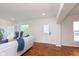 Bright living room featuring hardwood floors, neutral paint, and an abundance of natural light at 10745 Southeastern Ave, Indianapolis, IN 46239