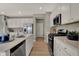 Modern kitchen featuring stainless steel appliances, granite countertops, and white cabinets at 10805 Soda Creek Ct, Indianapolis, IN 46239