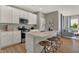 Modern kitchen featuring island seating, sleek countertops and stainless steel appliances and fixtures at 10805 Soda Creek Ct, Indianapolis, IN 46239