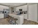 Modern kitchen features an island with seating, stainless appliances, and sleek countertops at 10805 Soda Creek Ct, Indianapolis, IN 46239