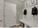 A mudroom featuring a bench, coat hooks, and a door to the garage at 10805 Soda Creek Ct, Indianapolis, IN 46239