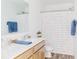 Bright bathroom with double sinks and a shower with a rainbow striped shower curtain, perfect for families at 1087 Stubble Run, Danville, IN 46122