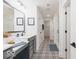Hall bathroom featuring dual sinks, a large mirror and designer tile flooring at 1087 Stubble Run, Danville, IN 46122