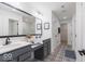 Hall bathroom featuring dual sinks, a large mirror, designer tile flooring and ample storage at 1087 Stubble Run, Danville, IN 46122