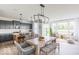 Elegant dining area with modern lighting, dining table, and seamless transition to the open kitchen at 1087 Stubble Run, Danville, IN 46122