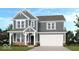 Charming two-story home featuring a two-car garage, gray siding, and a welcoming covered front entry at 1087 Stubble Run, Danville, IN 46122