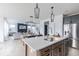 Open concept kitchen with island, bar seating, stainless appliances, flows to dining and living space at 1087 Stubble Run, Danville, IN 46122
