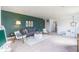 Bright living area has a gray sofa, accent chairs, and a decorative accent wall in a neutral color palette at 1087 Stubble Run, Danville, IN 46122
