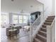 Inviting living room with stairs, a fireplace, large windows, and modern decor for relaxation and entertainment at 1087 Stubble Run, Danville, IN 46122