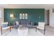 Cozy living room features a gray sofa, area rug, and dark green accent wall with matching decorations at 1087 Stubble Run, Danville, IN 46122