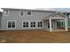 New construction house featuring light gray siding, white trim, covered patio, and multiple windows on the rear at 12417 Fresh Stock Dr, Noblesville, IN 46060
