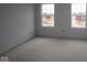 A bright, unfinished bedroom with two windows, ready to be transformed into a cozy retreat at 12417 Fresh Stock Dr, Noblesville, IN 46060