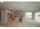 Bright kitchen with white cabinets, center island, recessed lighting and sliding door to the back yard at 12417 Fresh Stock Dr, Noblesville, IN 46060