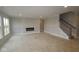 Living room with a modern fireplace and a staircase to the second floor at 12417 Fresh Stock Dr, Noblesville, IN 46060