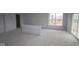 Spacious living room with a large window and sliding glass door, providing plenty of natural light at 12417 Fresh Stock Dr, Noblesville, IN 46060