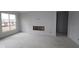 Bright living room featuring a large window and a fireplace, ready for finishing touches and personalization at 12417 Fresh Stock Dr, Noblesville, IN 46060