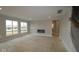 Bright Living room with a modern fireplace and windows overlooking the front yard at 12417 Fresh Stock Dr, Noblesville, IN 46060