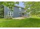 A two-story home with a spacious backyard, complemented by a well-manicured lawn and mature trees at 12449 Huntington Dr, Indianapolis, IN 46229