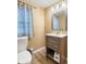Bathroom featuring wood grain vanity and drawers with a window at 12449 Huntington Dr, Indianapolis, IN 46229
