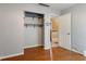 Bedroom with a built-in closet and a view into the hallway, featuring hardwood floors at 12449 Huntington Dr, Indianapolis, IN 46229