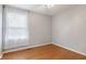Bright bedroom with natural light streaming through a large window and hardwood floors at 12449 Huntington Dr, Indianapolis, IN 46229