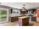 Contemporary kitchen with an island, dark cabinets, and stainless-steel appliances at 12449 Huntington Dr, Indianapolis, IN 46229