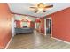 Spacious living room with an open concept design, ceiling fan, and stairway access at 12449 Huntington Dr, Indianapolis, IN 46229