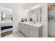 Bright bathroom with a double vanity, marble floors, and stylish decor, creating a luxurious and functional space at 1285 Chatham Hills Blvd, Westfield, IN 46074