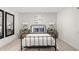 Bright bedroom with a black metal bed frame, patterned wallpaper, and two nightstands at 1285 Chatham Hills Blvd, Westfield, IN 46074