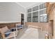 Covered patio with chairs, bench, brick accents, and view to the indoors through an open door at 1285 Chatham Hills Blvd, Westfield, IN 46074