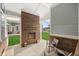 Covered outdoor patio featuring a brick fireplace, chairs, and view of the backyard at 1285 Chatham Hills Blvd, Westfield, IN 46074