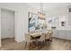 Elegant dining area featuring a modern chandelier, neutral decor, and seamless integration with the kitchen at 1285 Chatham Hills Blvd, Westfield, IN 46074