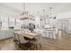 Open dining area with modern lighting, comfortable seating for eight, and convenient access to kitchen features at 1285 Chatham Hills Blvd, Westfield, IN 46074