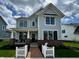 Charming two-story home featuring a covered front porch, brick accents, and a manicured front lawn at 1285 Chatham Hills Blvd, Westfield, IN 46074