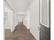 Bright hallway with wood flooring, white walls, modern sliding barn door, and neutral accents at 1285 Chatham Hills Blvd, Westfield, IN 46074