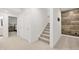 Bright hallway featuring carpeted stairs, white walls, and views into the bedroom at 1285 Chatham Hills Blvd, Westfield, IN 46074