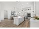 Open-concept kitchen with a large island, stainless steel appliances, and a seamless transition to the dining area at 1285 Chatham Hills Blvd, Westfield, IN 46074