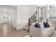 Bright and airy living room featuring hardwood floors and a modern staircase at 1285 Chatham Hills Blvd, Westfield, IN 46074