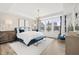 Luxurious main bedroom with a large window, tray ceiling, and elegant decor, creating a serene retreat at 1285 Chatham Hills Blvd, Westfield, IN 46074