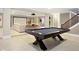 Finished basement with a pool table, projector screen, and ample seating for entertaining at 13855 Waterway Blvd, Fishers, IN 46040