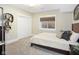 Cozy bedroom features a large window, plush carpeting, and a stylish decorative bookshelf with a modern design at 13855 Waterway Blvd, Fishers, IN 46040