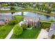 Stunning aerial view of home with large yard, pond, pool, and tennis courts in desirable community at 14145 Charity Chase Cir, Carmel, IN 46074